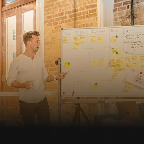 Strategist presenting a B2B growth plan at a whiteboard