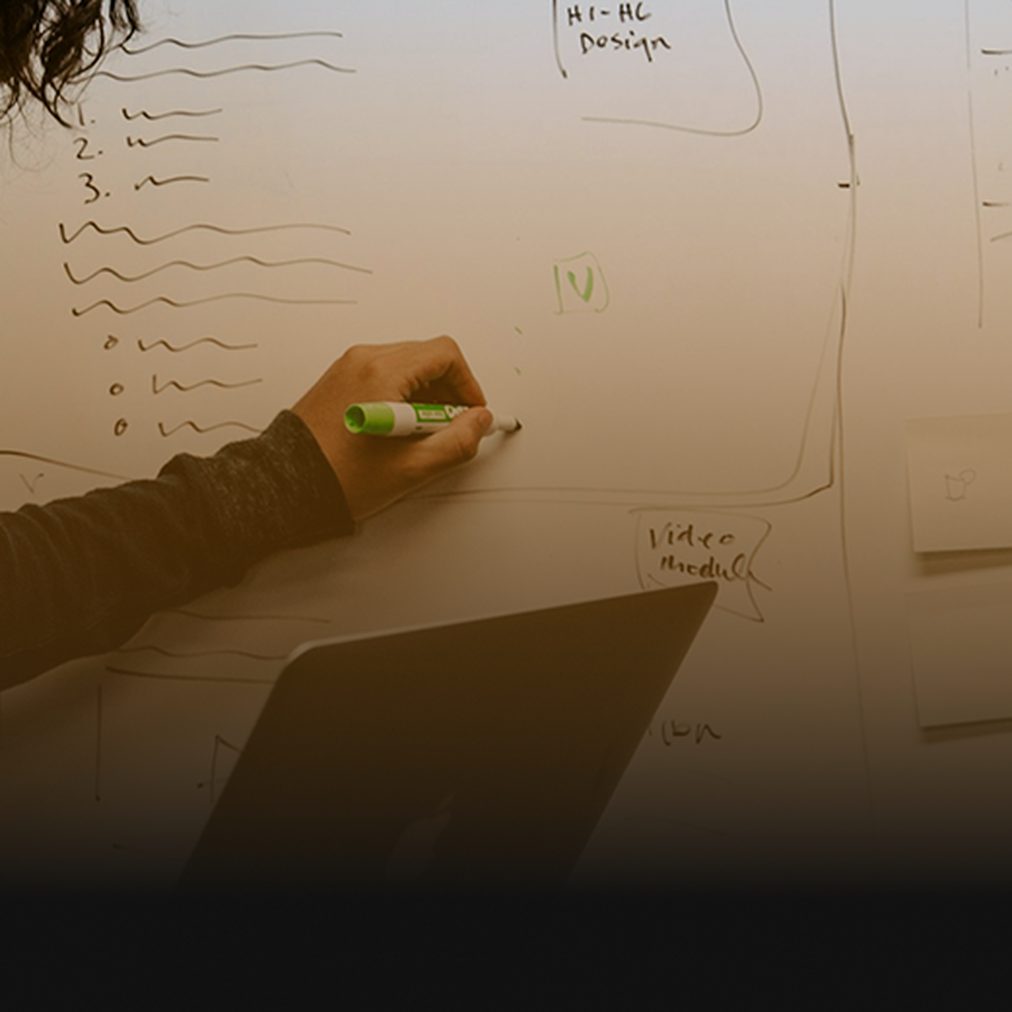 Planning paid media budgets on a whiteboard