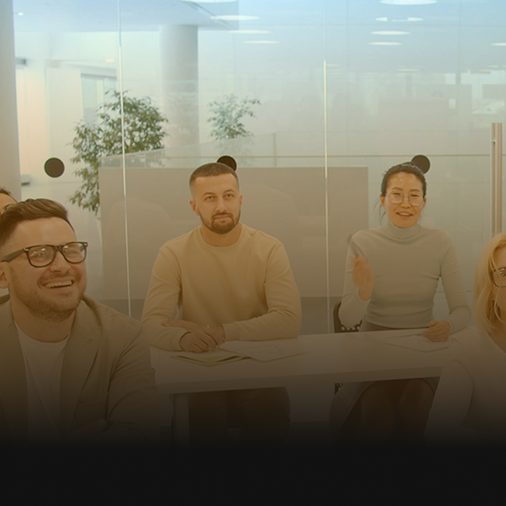 AlchemyLeads team reviewing revenue results on a display screen
