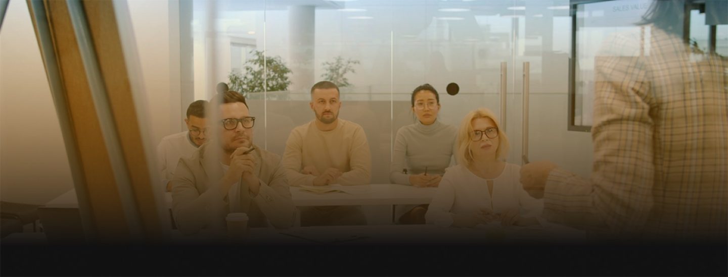 Team mapping AI search strategy on a glass wall