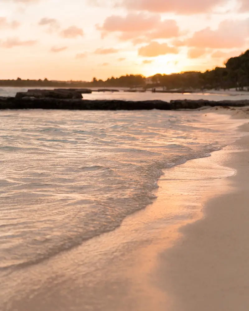 Golden sunset light over a quiet beach