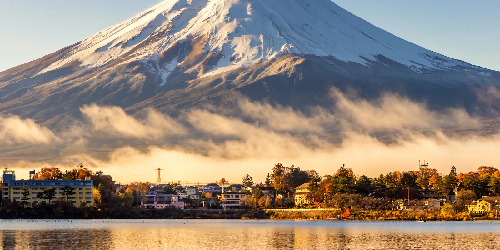 Mount Fuji reflected in a calm lake at dawn
